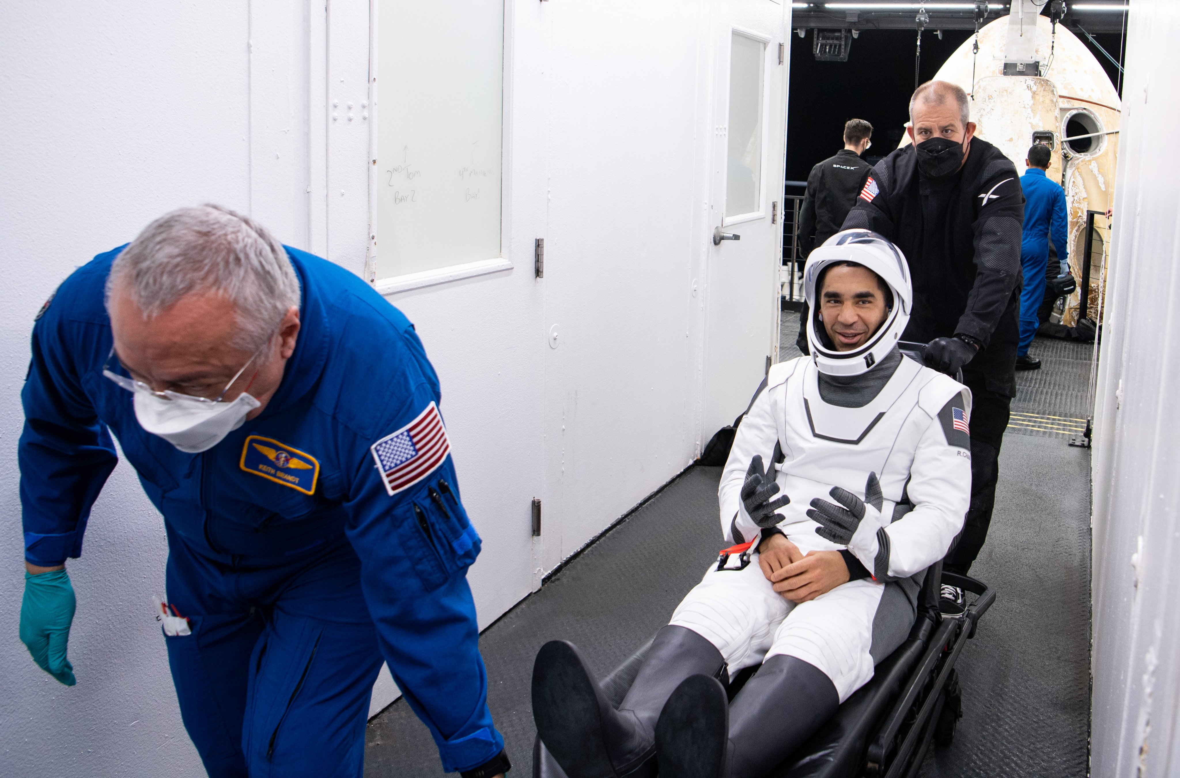 NASA astronaut Raja Chari greets friends after being helped out of the SpaceX Crew Dragon Endurance spacecraft onboard the SpaceX Shannon recovery ship.