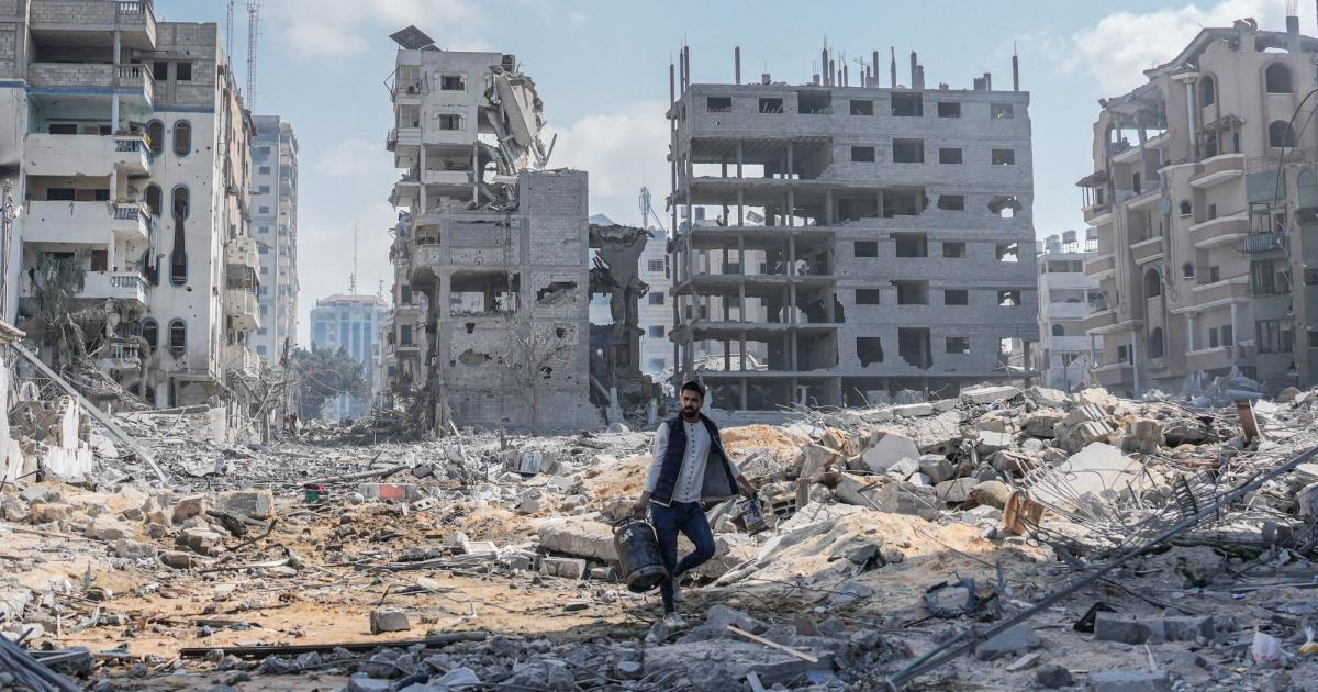 Gaza_Man walking on rubble_RS106661