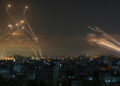 The Israeli Iron Dome missile defence system (L) intercepts rockets (R) fired by the Hamas movement towards southern Israel from Beit Lahia in the northern Gaza Strip as seen in the sky above the Gaza Strip overnight on May 14, 2021. - Israel bombarded Gaza with artillery and air strikes on Friday, May 14, in response to a new barrage of rocket fire from the Hamas-run enclave, but stopped short of a ground offensive in the conflict that has now claimed more than 100 Palestinian lives.
As the violence intensified, Israel said it was carrying out an attack "in the Gaza Strip" although it later clarified there were no boots on the ground. (Photo by ANAS BABA / AFP)