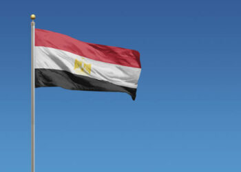 Flag of Egypt in front of a clear blue sky